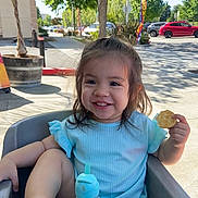 Ila is registered to the contest to win money with this photo: child, city, cream, dessert, face, female, food, head, icecream, lunch, meal, person, photography, plant, portrait, pottedplant, road, street, summer, urban