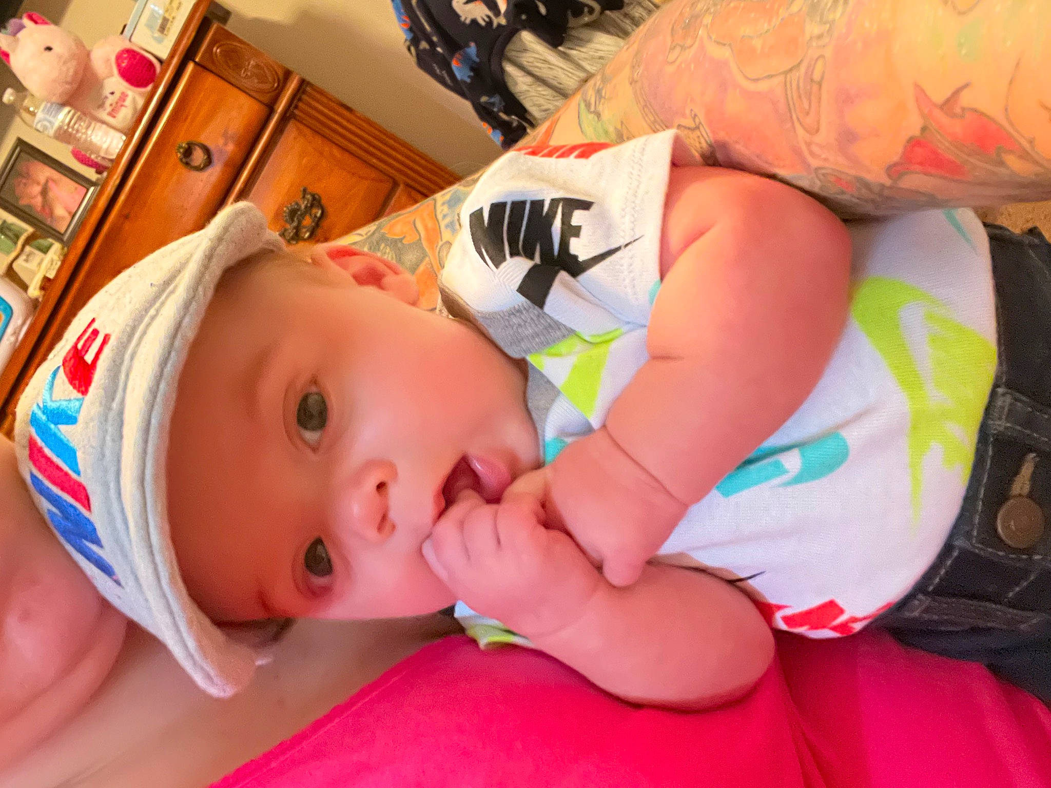 Nehemiah is registered to the contest to win money with this photo: arm, baby, baby_products, baby_toddler_clothing, cheek, chest, child, comfort, eyelash, finger, fun, happy, headwear, mouth, nail, orange, person, product, shelf, skin