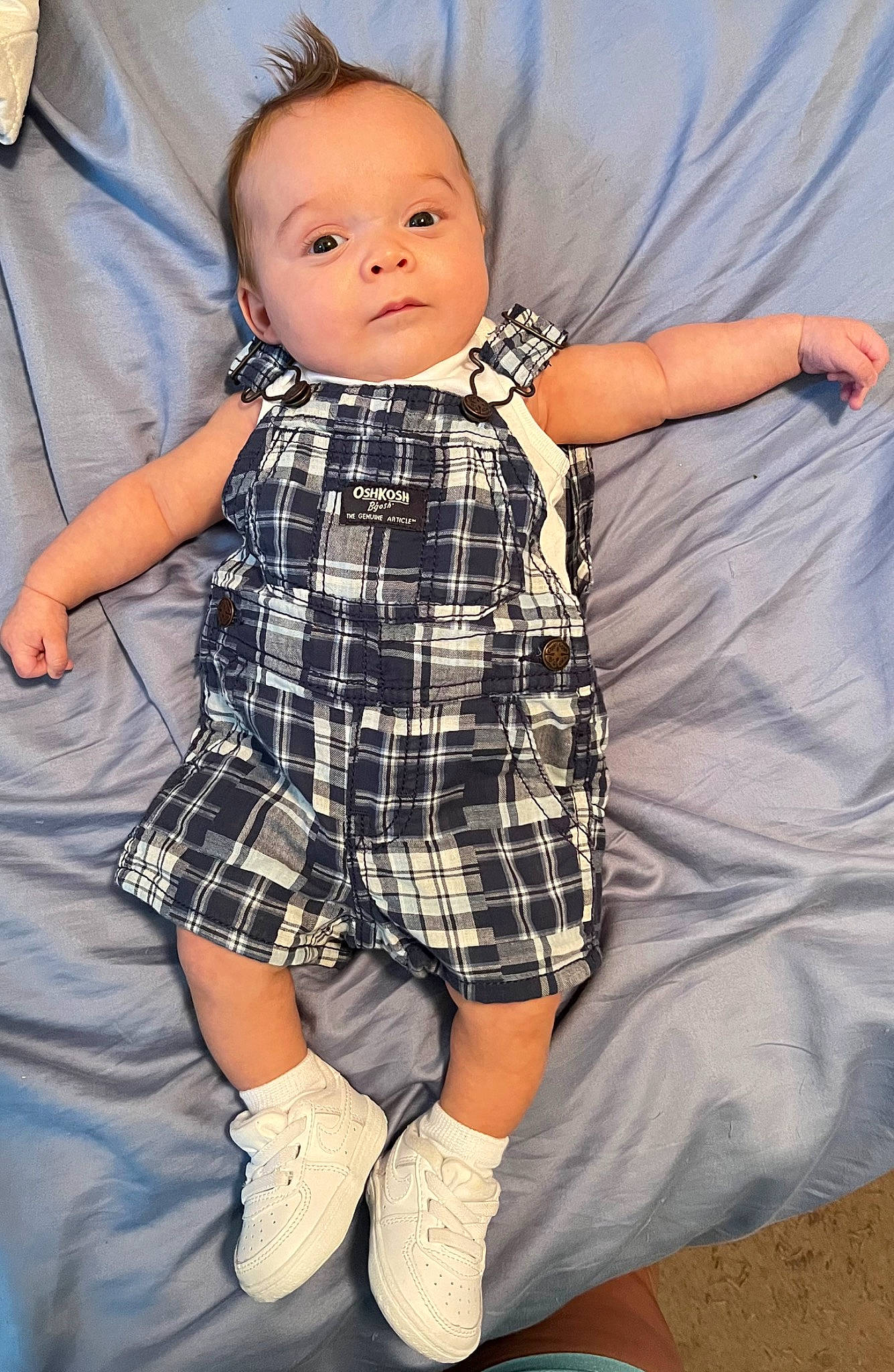 Nehemiah is registered to the contest to win money with this photo: baby, baby_toddler_clothing, child, dress_shirt, face, fun, gesture, hand, happy, human, pattern, person, plaid, skin, sleeve, sock, t_shirt, tartan, textile, toddler