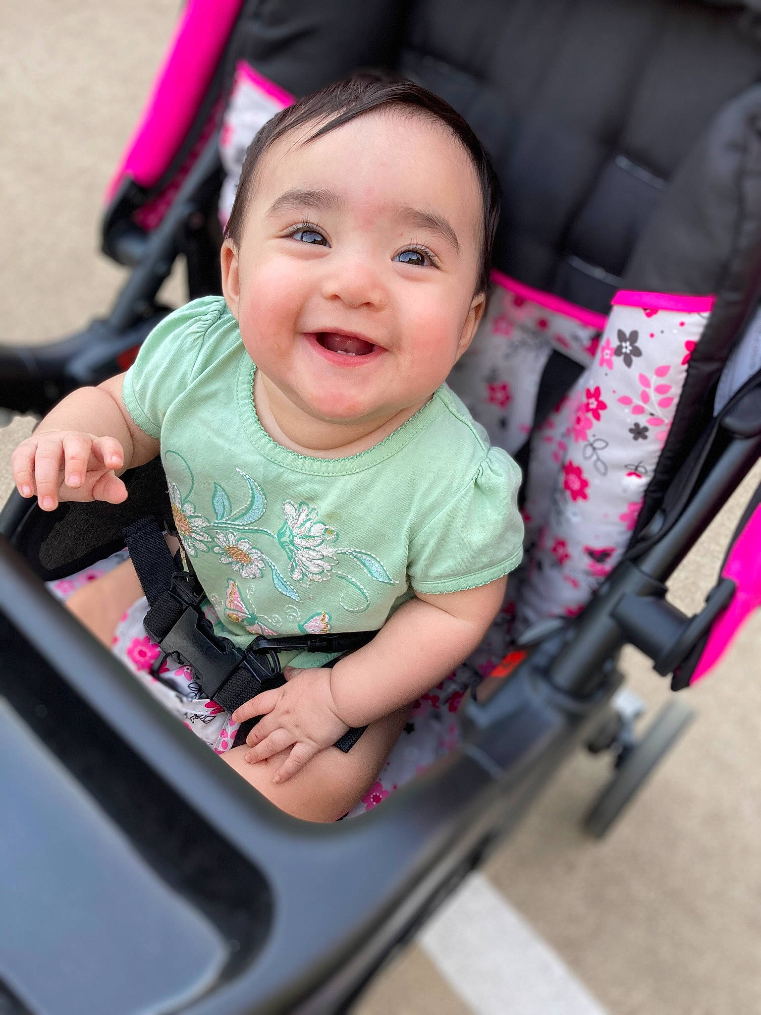 Avery is registered to the contest to win money with this photo: arm, auto_part, baby, baby_carriage, cheek, eye, facial_expression, finger, fun, hairstyle, hand, happy, head, joy, motor_vehicle, person, pink, product, skin, smile