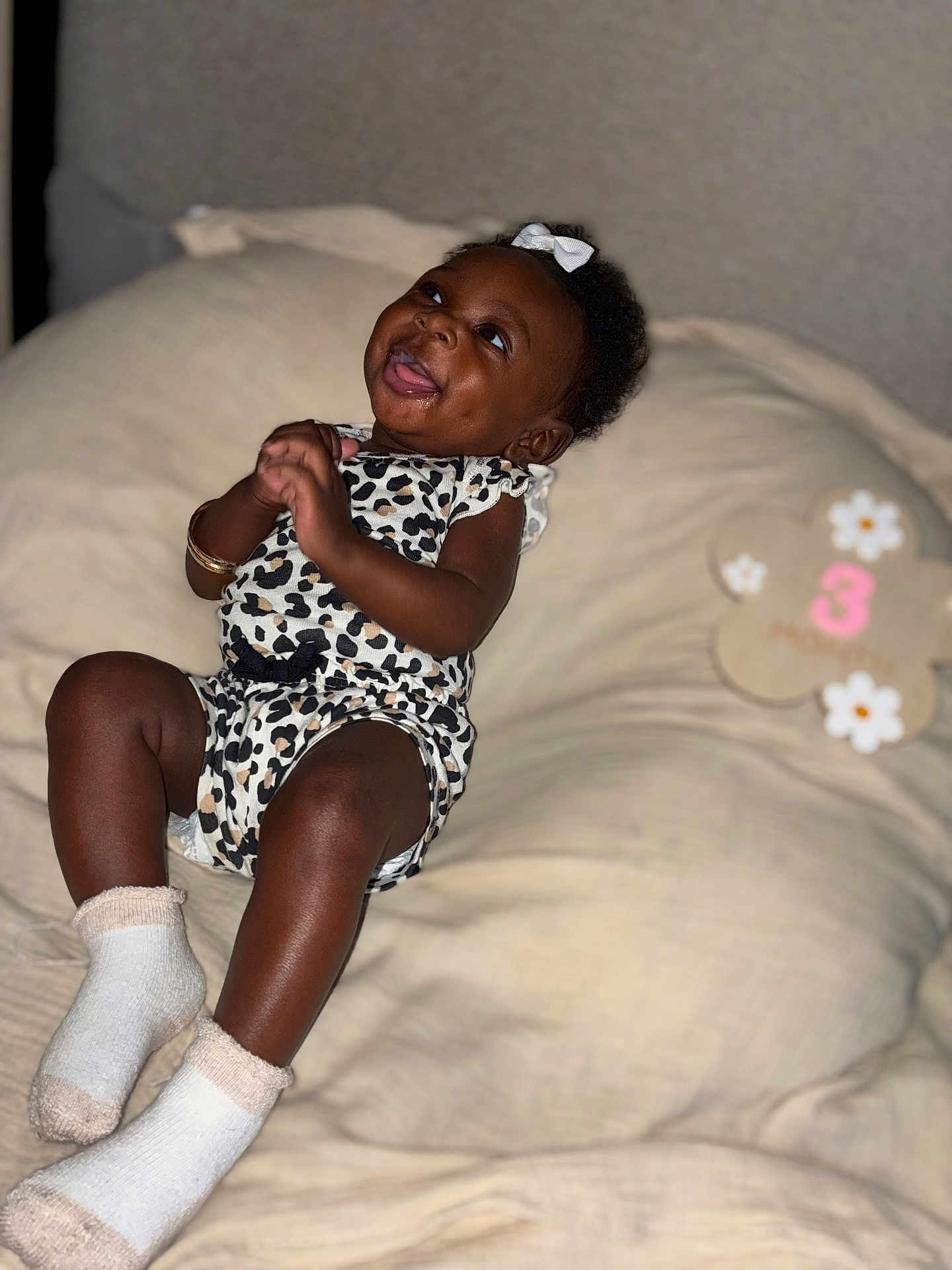 Syiana joined the competition — help win amazing prizes! baby, infant, smiling, leopard_print, white_socks, bow, bed, blanket, happy, portrait, cute, celebration, milestone, child, indoor, person, lying_down, decor, soft, cozy