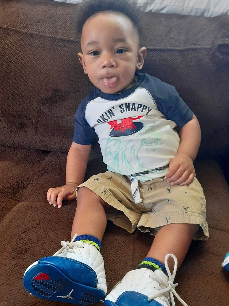 Jakobi is registered to the contest to win money with this photo: arm, baby, baby_toddler_clothing, blue, cheek, child, cool, footwear, jeans, knee, leg, person, play, shoe, sitting, skin, t_shirt, toddler