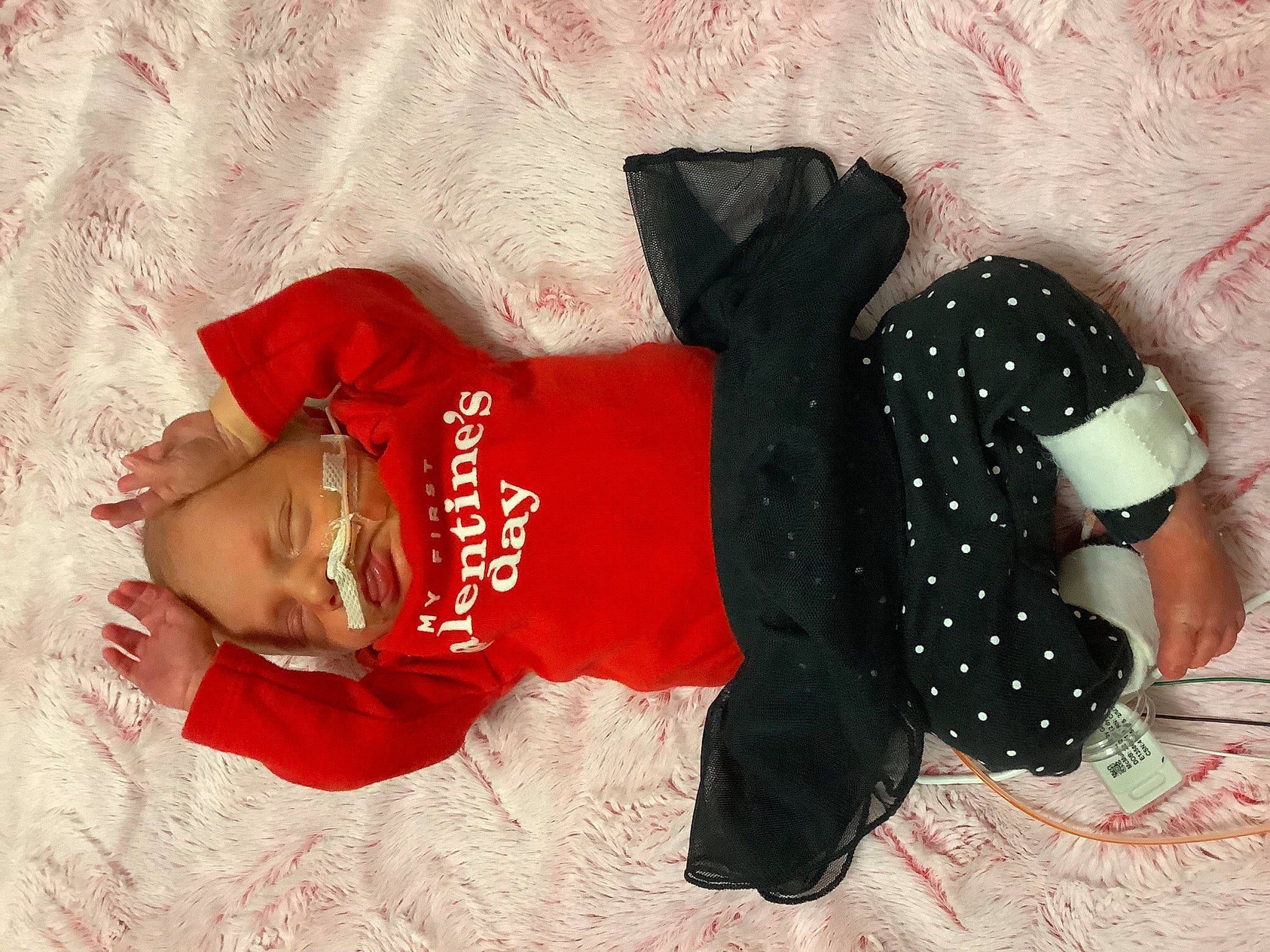 Oakley is registered to the contest to win money with this photo: baby_toddler_clothing, carmine, child, fashion_accessory, flooring, font, gesture, headgear, human_leg, linens, pattern, person, polka_dot, sleeve, sportswear, t_shirt, textile, thigh, toddler, visual_arts