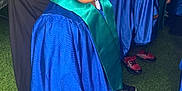Carson joined the competition — help win amazing prizes! child, graduation, blue_gown, graduation_cap, smiling, green_stole, indoor, group, people, black_shoes, braided_hair, happy, celebration, portrait, event, young_student, education, ceremony, person, crowd