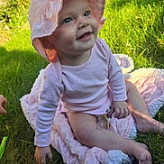 Lilah joined the competition — help win amazing prizes! baby, child, pink_hat, pink_clothing, blanket, grass, outdoor, smiling, happy, sunlight, sitting, cute, infant, nature, headwear, toddler, skin, one_person, daylight, playful