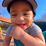 Eithan joined the competition — help win amazing prizes! baby, blue_sky, cap, child, clothing, cute, daylight, expression, face, happy, infant, outdoor, person, playground, portrait, skin, smiling, sunlight, swing, young_child