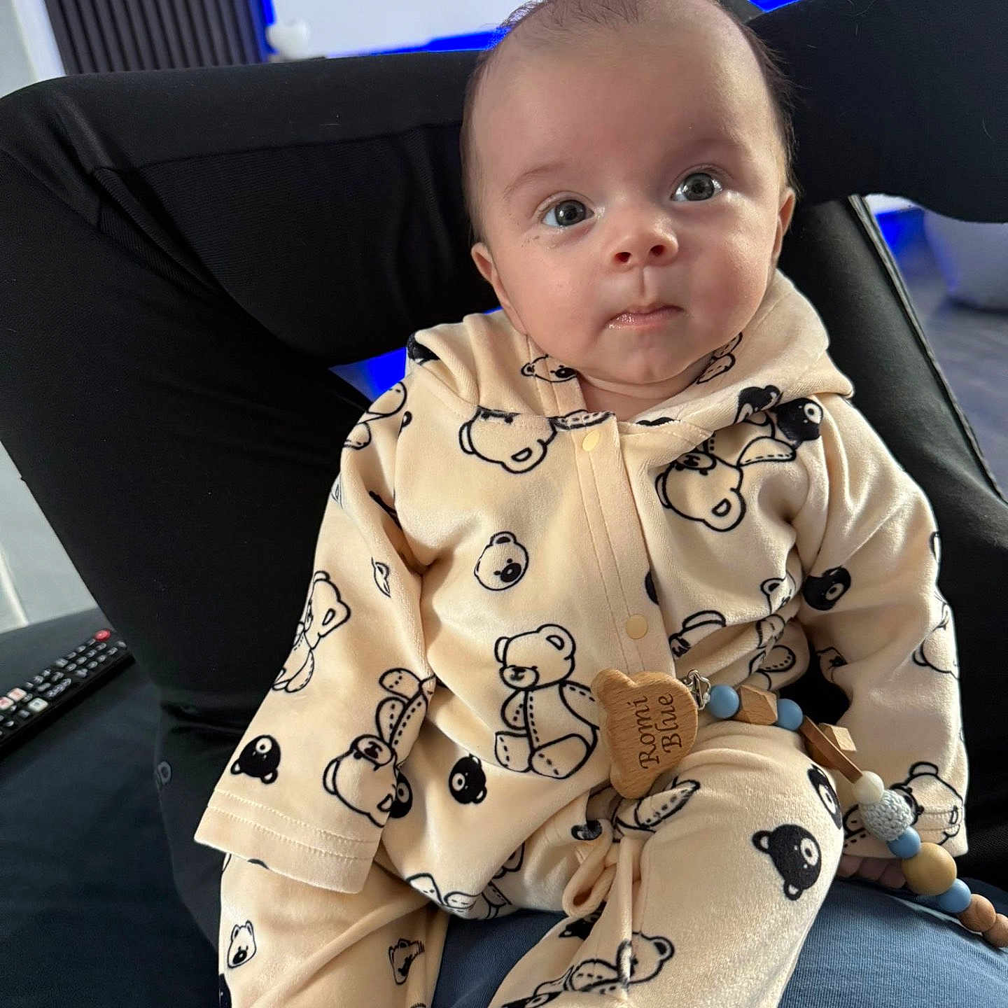 Romi Blue joined the competition — help win amazing prizes! baby, blanket, chair, clothing, couch, cushion, electronics, face, frown, furniture, head, homedecor, pajamas, person, photography, portrait, remotecontrol, sitting, skin, tattoo