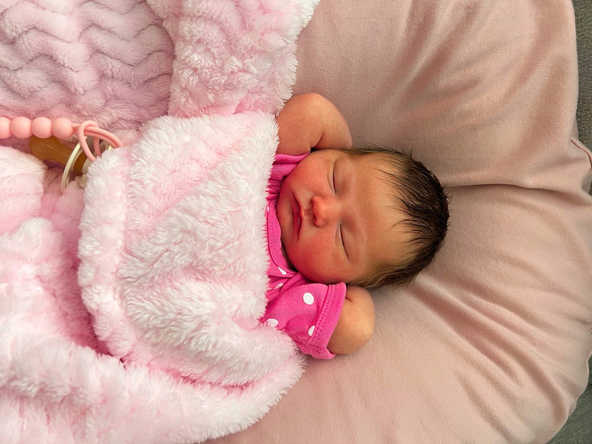 Delaney is registered to the contest to win money with this photo: baby, baby_products, baby_sleeping, baby_toddler_clothing, bedding, bedtime, cheek, child, comfort, couch, eye, eyelash, hand, human_body, linens, mammal, person, pink, skin, textile