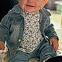 baby, blanket, blue_eyes, child, clothing, cozy, cute, denim_jacket, denim_pants, floral_top, footwear, happy, indoor, infant, pattern, person, portrait, sitting, smile, tousled_hair