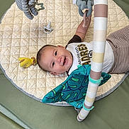 Aiden joined the competition — help win amazing prizes! baby, infant, child, smiling, happy, portrait, play_mat, baby_gym, plush_toy, hanging_toy, pacifier, activity_bar, striped_toy, onesie, blanket, lying_down, indoor, playtime, face, photography
