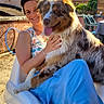 Urkane a rejoint le concours — aidez-le/la à gagner de superbes lots ! animal, blue_skirt, building, casual_clothing, chair, daylight, dog, friendly, garden, happy, outdoor, person, pet, relaxing, smiling, summer, sunlight, tongue_out, white_chair, woman