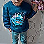 Keyla Claine participe au concours pour gagner de l'argent avec cette photo : artwork, black_shoes, blue_sweatshirt, casual_clothing, child, curious_expression, face, flooring, hair, illustration, indoor, light, pants, person, plush_toy, standing, stitch_character, toy, wall_drawings, young_child
