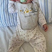 Abel Claine participe au concours pour gagner de l'argent avec cette photo : baby, bed, bib, child, clothing, cute, face, hand, indoors, infant, newborn, onesie, pacifier, peaceful, pillow, portrait, resting, sleeping, striped_pillowcase, white_sheet