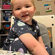 Oliver joined the competition — help win amazing prizes! toddler, child, smiling, high_chair, pajamas, space_theme, indoor, toys, artwork, wall, furniture, face, person, cute, happy, blond_hair, tablecloth, drawing, room, baby