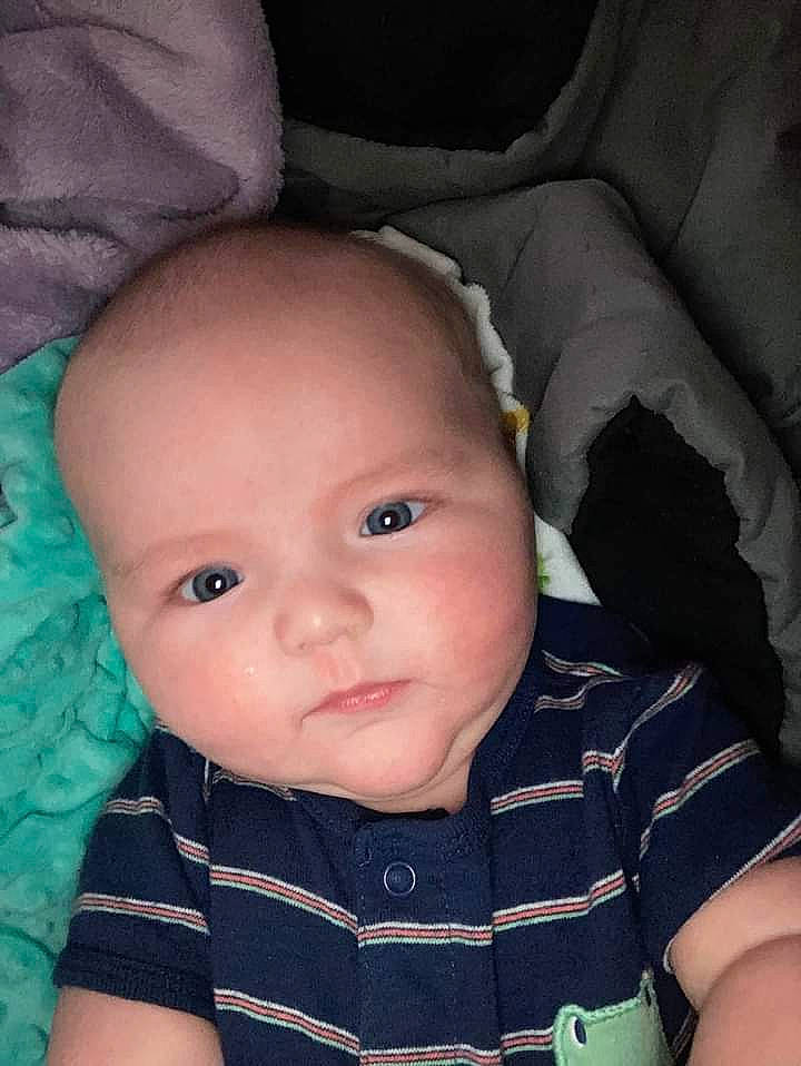 Oliver is registered to the contest to win money with this photo: baby, baby_toddler_clothing, black, cheek, comfort, eyebrow, eyelash, face, flash_photography, head, iris, lip, mouth, nose, person, skin, sleeve, smile, textile, toddler