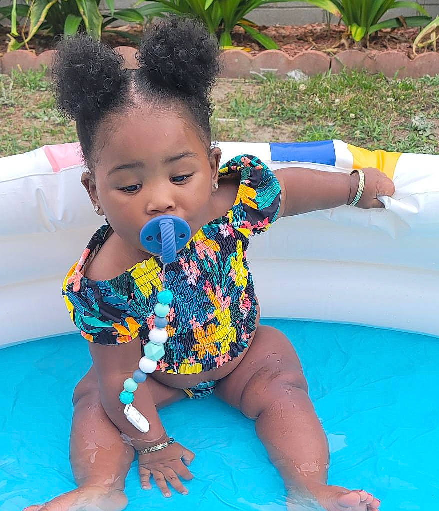 Jeyonnah is registered to the contest to win money with this photo: aqua, arm, baby, baby_toddler_clothing, child, finger, fun, green, hair, happy, head, leisure, person, plant, recreation, skin, summer, swimming_pool, thigh, toddler