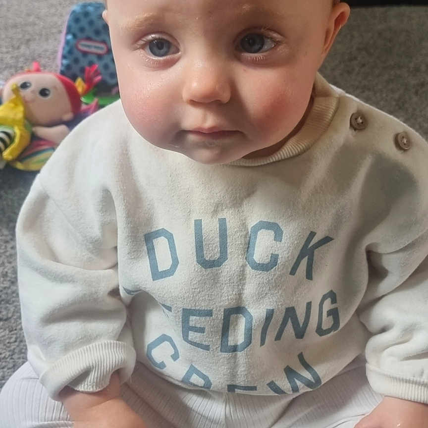 Neaveh joined the competition — help win amazing prizes! baby, blue_eyes, butterfly, carpet, child, clothing, cute, expression, face, hair_clip, hands, indoor, infant, legs, person, sitting, socks, sweater, toy, white