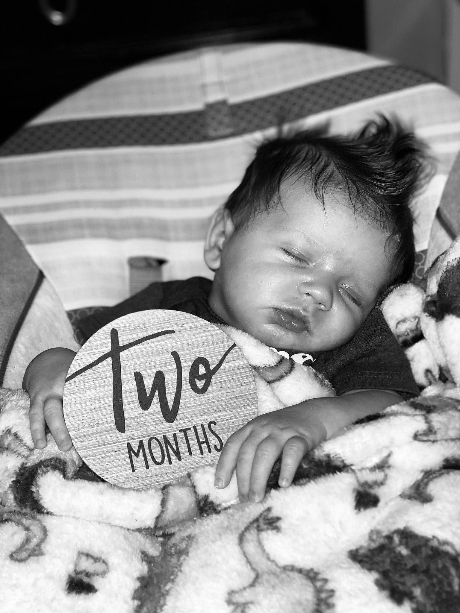 Tyler is registered to the contest to win money with this photo: baby, baby_toddler_clothing, black, black_and_white, cheek, child, comfort, eye, finger, happy, head, human_body, iris, monochrome, monochrome_photography, person, photograph, skin, style, textile