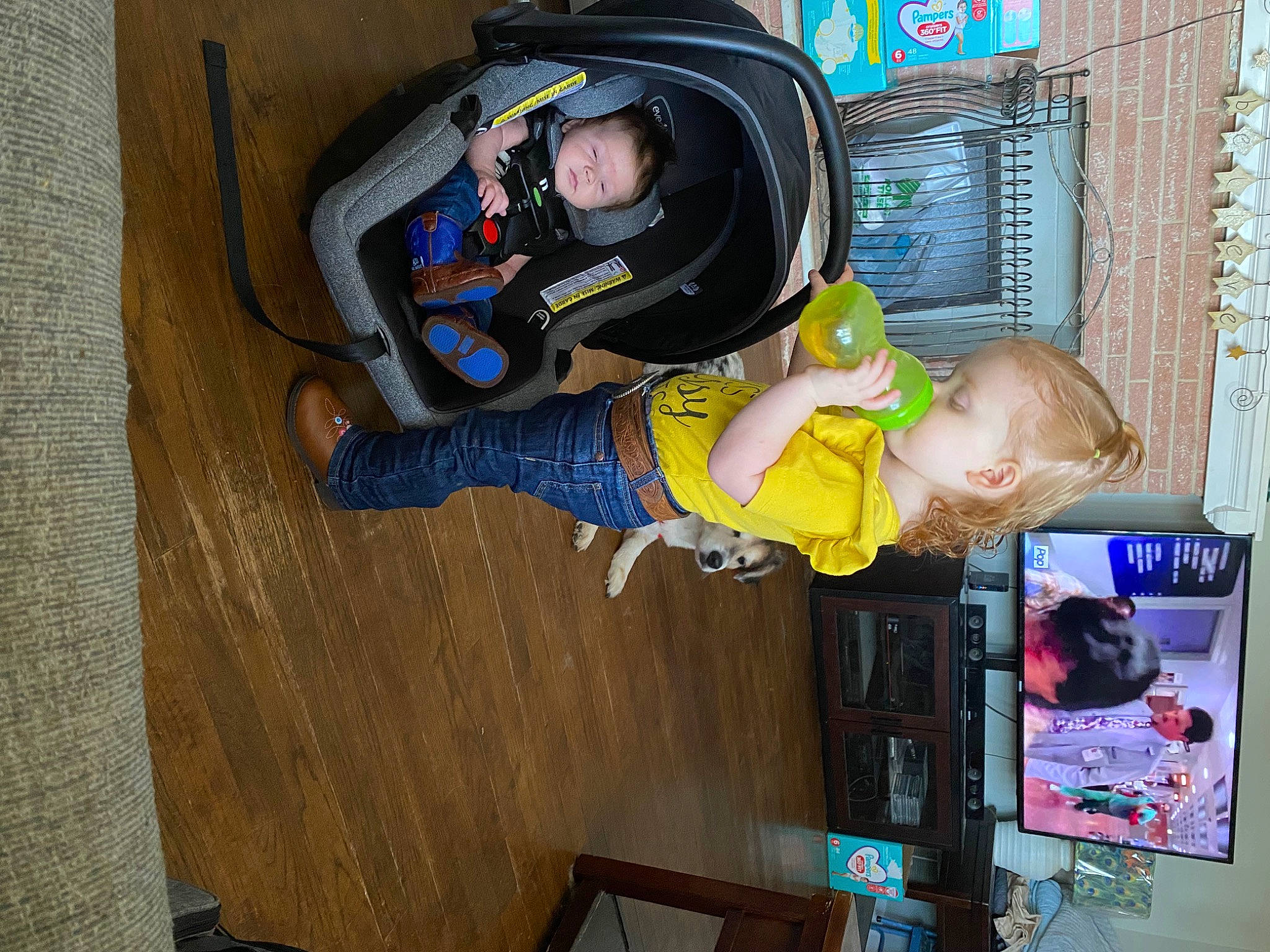 Kaelyn is registered to the contest to win money with this photo: baby, baby_toddler_clothing, child, comfort, fun, hardwood, person, personal_protective_equipment, play, room, t_shirt, toddler, walking_shoe, wood