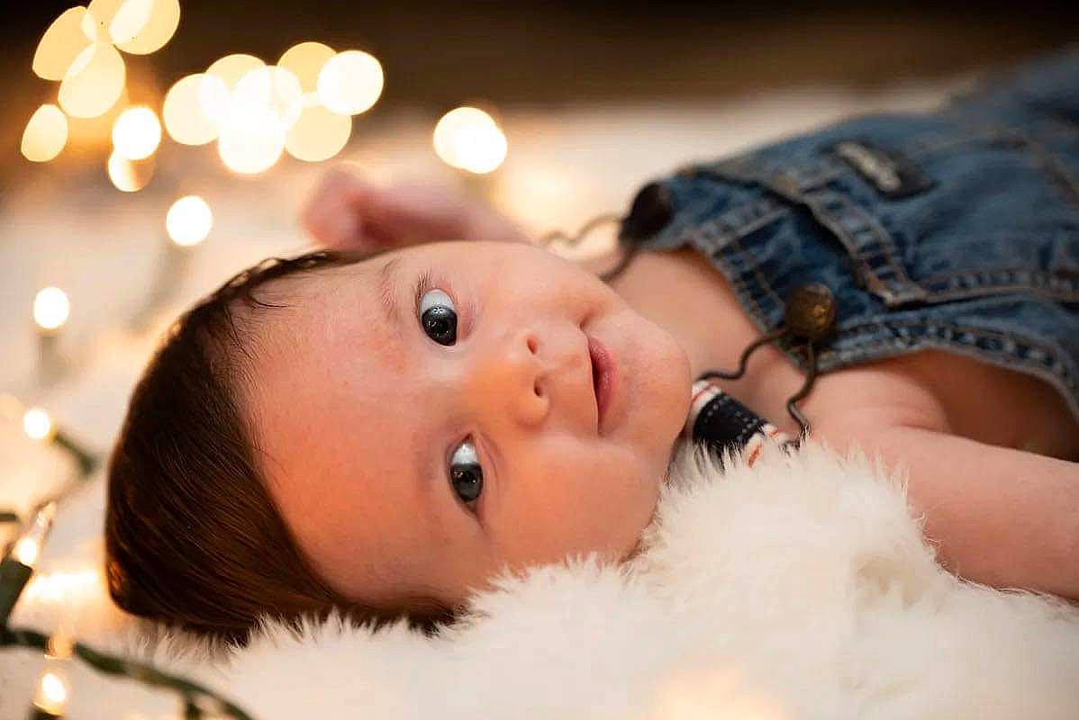 Bowen is registered to the contest to win money with this photo: baby, beauty, child, couch, event, eyelash, fashion_accessory, flash_photography, fun, fur, fur_clothing, happy, holiday, lip, ornament, person, portrait_photography, skin, toddler, toy