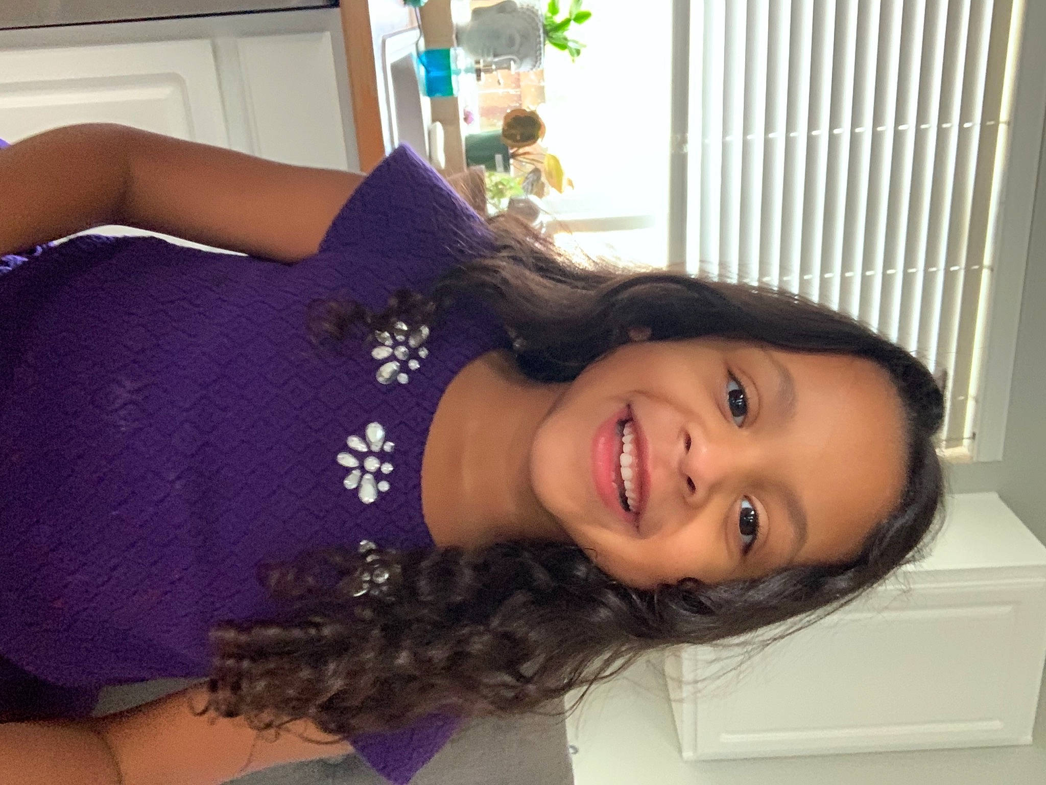 Emmery is registered to the contest to win money with this photo: arm, black_hair, dress, eyelash, happy, jewellery, joint, joy, lip, long_hair, mouth, neck, person, plant, purple, shoulder, sleeve, smile, thigh, trunk