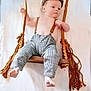 baby, child, swing, wooden_swing, ropes, checkered_pants, suspenders, cap, bare_chest, feet, hands, white_background, indoor, infant, cute, portrait, clothing, person, fashion, relaxing