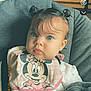 baby, bib, blanket, blue_eyes, car_seat, child, chubby_cheeks, close_up, cozy, cute, hair_buns, harness, indoor, infant, minnie_mouse, mobile_ui, portrait, screenshot, soft_lighting, timestamp