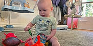 Joseph joined the competition — help win amazing prizes! toddler, child, toy, carpet, indoor, phone_toy, plastic_toy, giraffe_toy, fan, coat, window, door, baby_swing, car_toy, foot, shirt, person, floor, room, curious