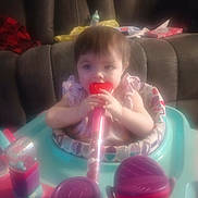 Raven joined the competition — help win amazing prizes! baby, child, infant, car, car_seat, activity_center, bottle, pacifier, sitting, indoor, portrait, face, brown_hair, eyes, hands, colorful, toy, tissues, backseat, family_travel