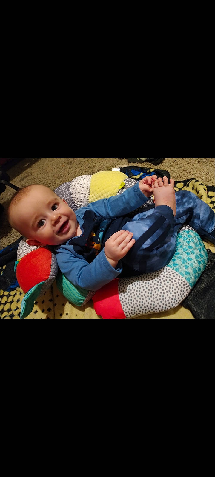 Tony is registered to the contest to win money with this photo: baby, baby_products, child, comfort, couch, flash_photography, fun, gesture, grass, happy, interaction, joy, laugh, leisure, outerwear, pattern, person, portrait_photography, room, sitting