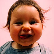 éléonore participe au concours pour gagner de l'argent avec cette photo : baby, face, tongue, smile, cheeks, child, portrait, cute, happy, pink_background, young, infant, expression, clothing, hair, skin, closeup, one_person, indoors, playful