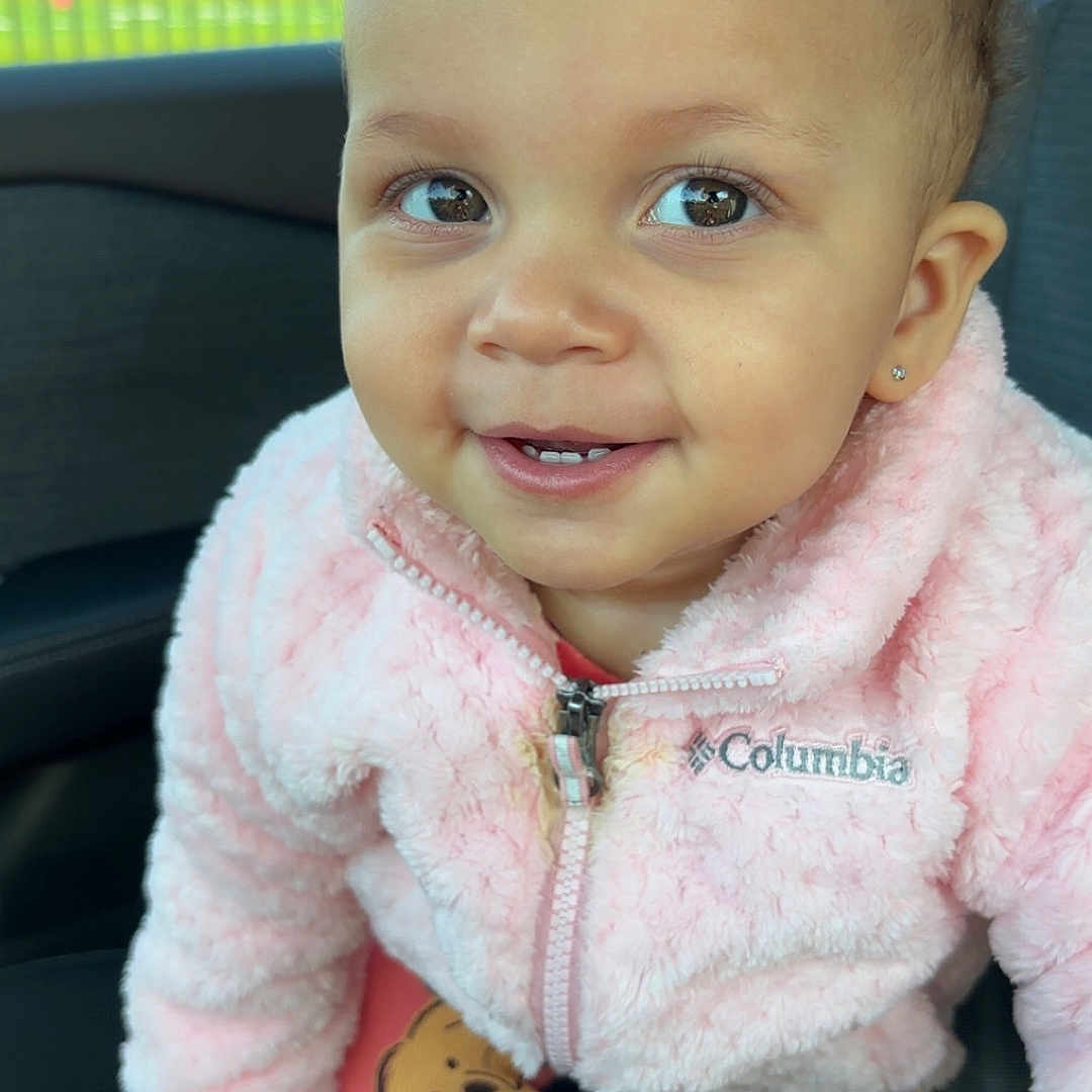 Calise joined the competition — help win amazing prizes! accessories, baby, bodypart, clothing, coat, face, happy, head, hoodie, jacket, knitwear, mouth, pants, person, photography, portrait, sitting, smile, sweater, sweatshirt