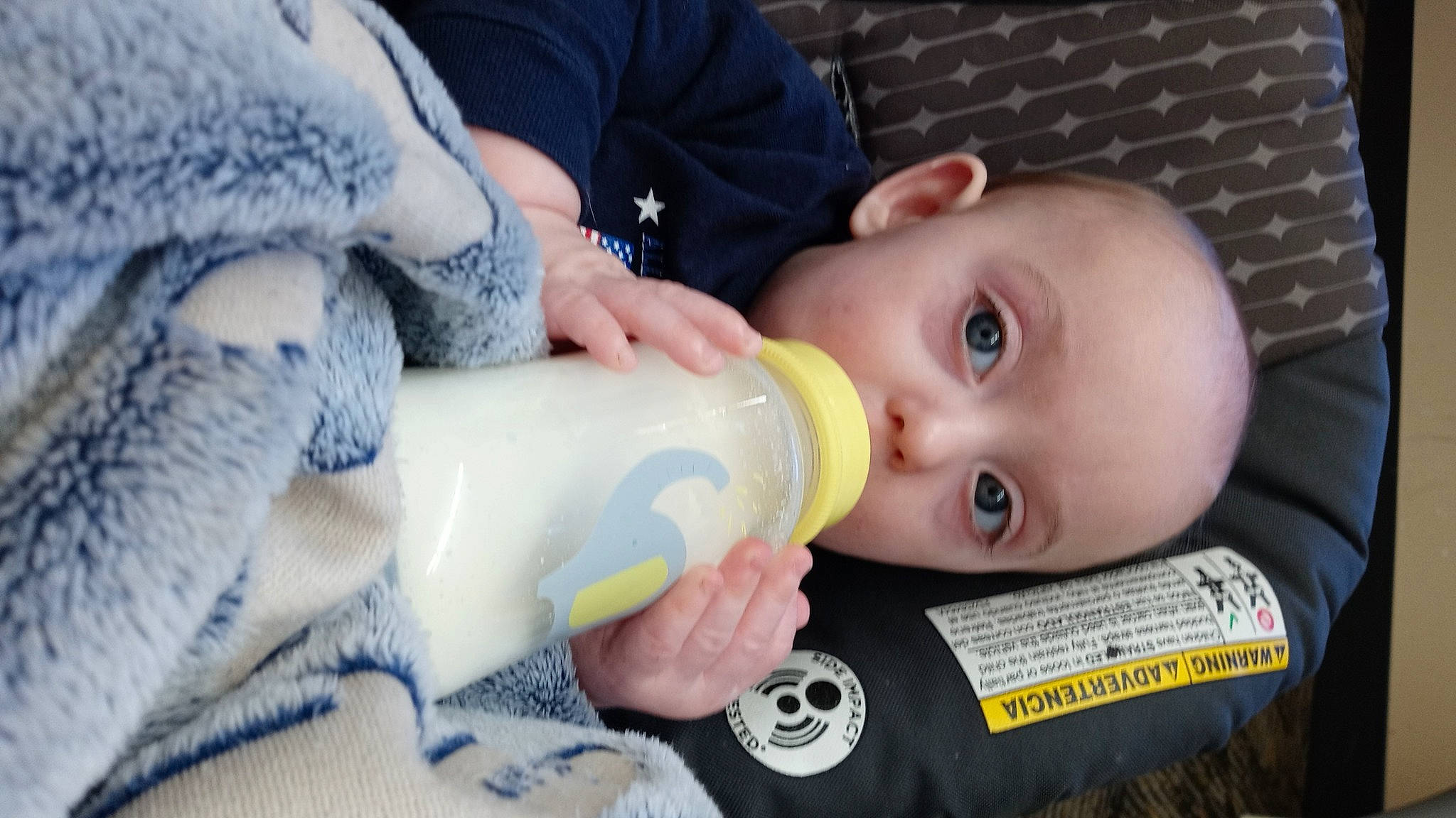 Kalvin is registered to the contest to win money with this photo: baby, baby_bottle, baby_toddler_clothing, bottle, cheek, drink, drinking, drinkware, ear, eye, eyelash, infant_formula, iris, lip, mouth, nose, person, plastic_bottle, skin, toddler