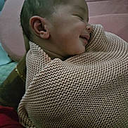 Luna is registered to the contest to win money with this photo: baby, child, smiling, blanket, knit, cozy, sleeping, peaceful, portrait, face, head, person, infant, cute, warm, comfort, wrapped, hand, skin, indoors