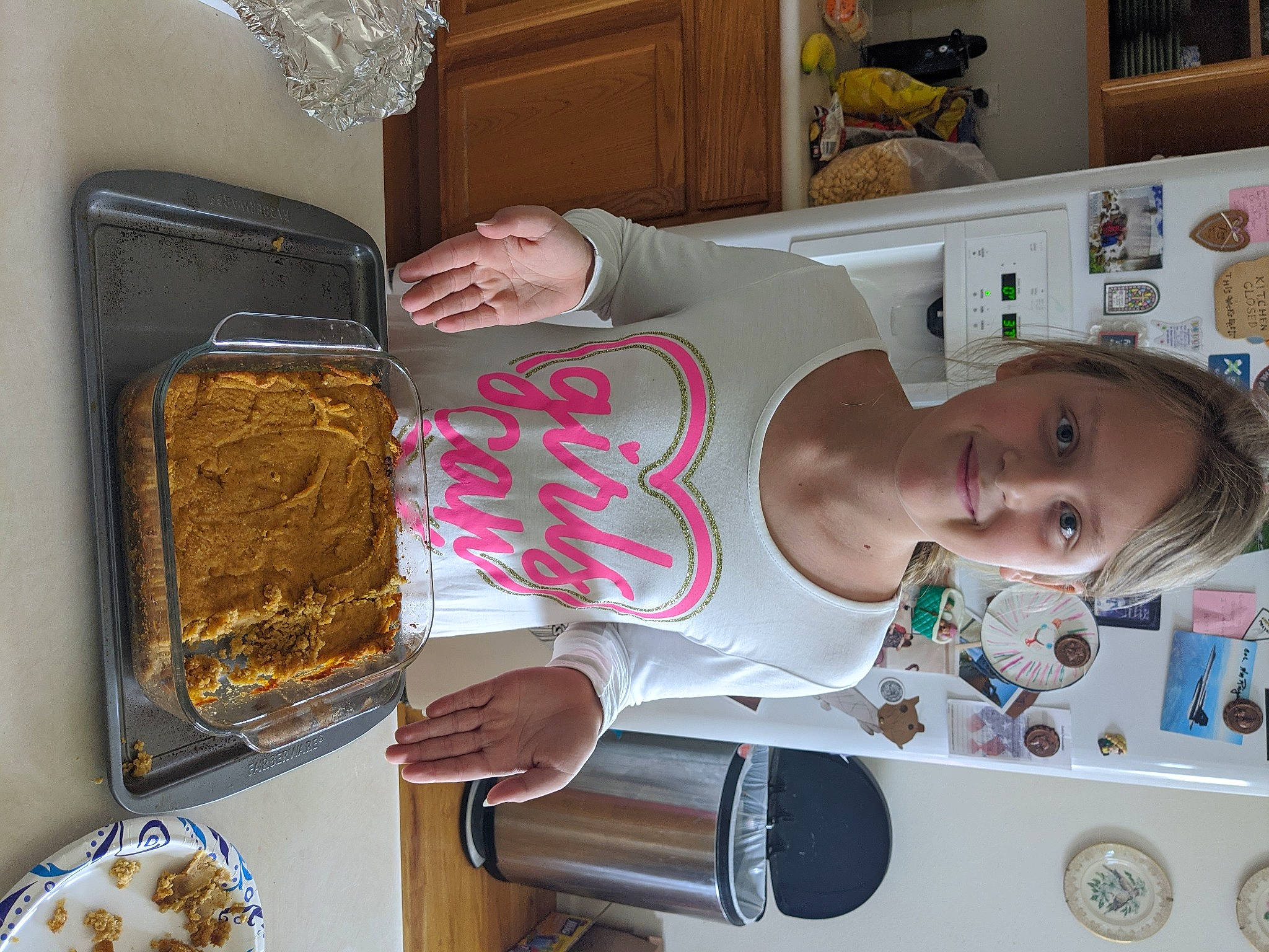 Addison is registered to the contest to win money with this photo: baby, child, cooking, dish, food, homemaker, joy, major_appliance, person, picture_frame, plate, platter, room, serveware, shelf, smile, tableware, toddler