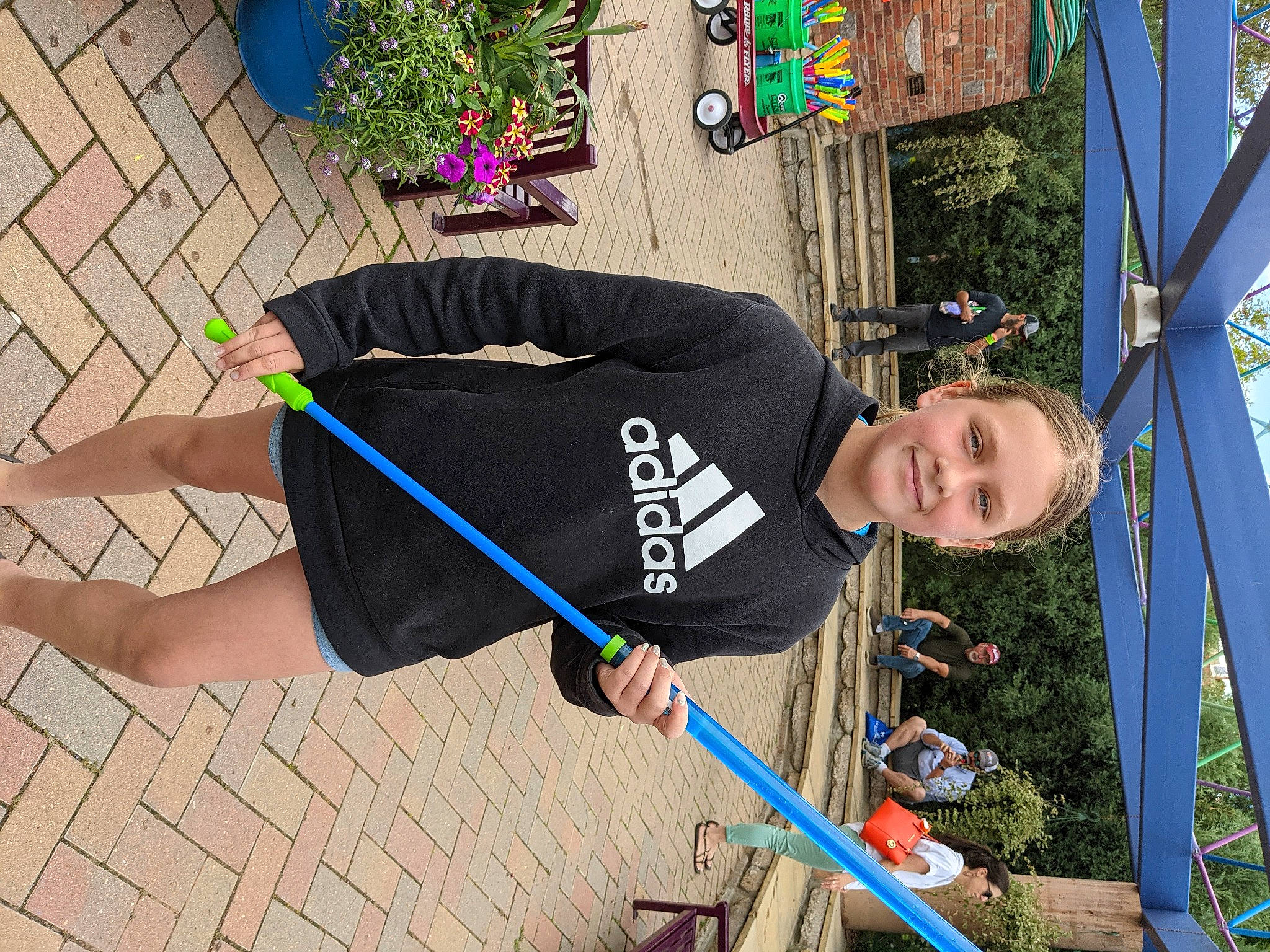 Addison is registered to the contest to win money with this photo: balance, child, electric_blue, flowerpot, fun, houseplant, joy, leisure, outdoor_play_equipment, person, plant, play, pole, recreation, rope, smile, sportswear, street_fashion, t_shirt, tree