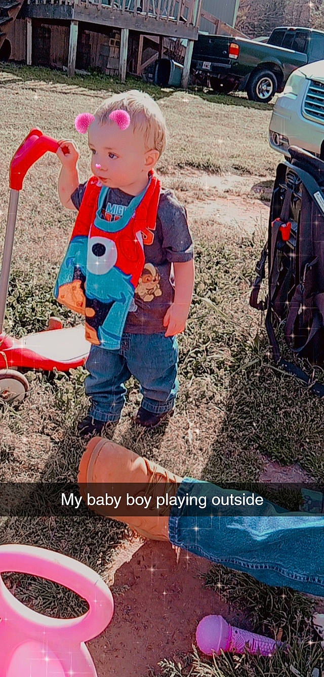 Hunter is registered to the contest to win money with this photo: automotive_tire, baby_toddler_clothing, child, fun, grass, happy, leisure, people, people_in_nature, person, photograph, product, recreation, snapshot, sneakers, t_shirt, tire, toddler, travel, vehicle