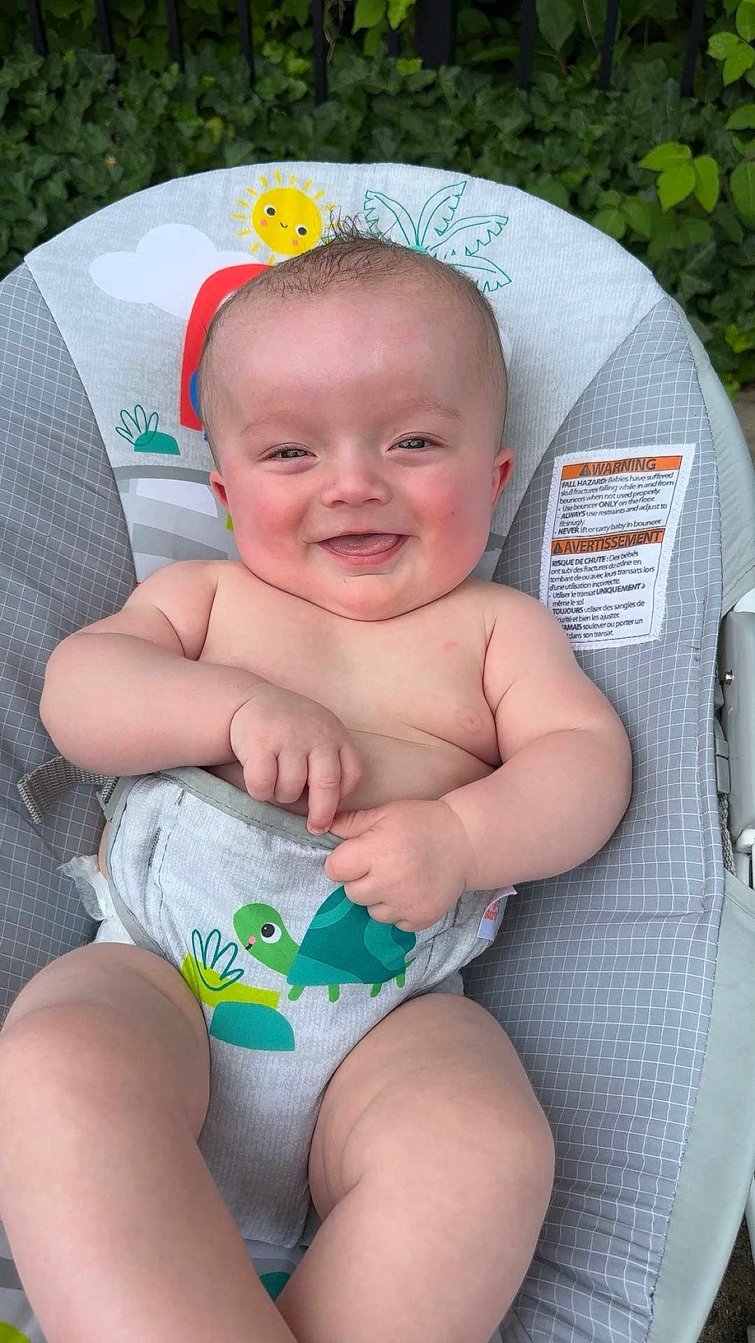 Christian is registered to the contest to win money with this photo: baby, smiling, diaper, baby_seat, cute, chubby, infant, outdoor, greenery, sun_illustration, cloud_illustration, happy, skin, hands, legs, head, face, child, seat, nature