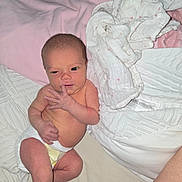 Lilah is registered to the contest to win money with this photo: baby, bed, blanket, cozy, cute, diaper, face, finger, hand, infant, lying_down, newborn, newborn_baby, person, pink, resting, skin, sleepwear, soft, white