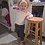 Monroe is registered to the contest to win money with this photo: brushing_teeth, cabinet, candid, child, countertop, curly_hair, floral_shoes, hand_on_stool, headband, indoor, kitchen, long_sleeve, pants, shoes, sippy_cups, smiling, toddler, toothbrush, toys, wooden_stool