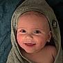baby, child, smiling, face, towel, wrapped, blue_eyes, happy, skin, closeup, infant, cute, portrait, warm, soft_texture, blanket, indoors, young, head, expression