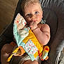 Raphaël participe au concours pour gagner de l'argent avec cette photo : baby, infant, child, blue_eyes, blonde_hair, thumb_sucking, soft_toy, plush_duck, colorful_toy, baby_chair, cushion, indoor, natural_light, rosy_cheeks, cute, chubby_arms, comfort, relaxed, seated, portrait