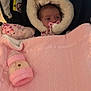 baby, pacifier, blanket, bottle, pink, warm_clothing, hood, infant, car_seat, child, sleepy, cozy, indoor, feeding, cute, resting, soft_texture, portrait, newborn, wrapped