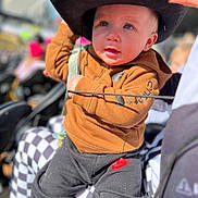 Summit joined the competition — help win amazing prizes! toddler, child, hat, cowboy_hat, hoodie, nike, pants, checkered_pattern, person, outdoor, daylight, curious, seated, closeup, face, expression, baby, clothing, people, blurred_background