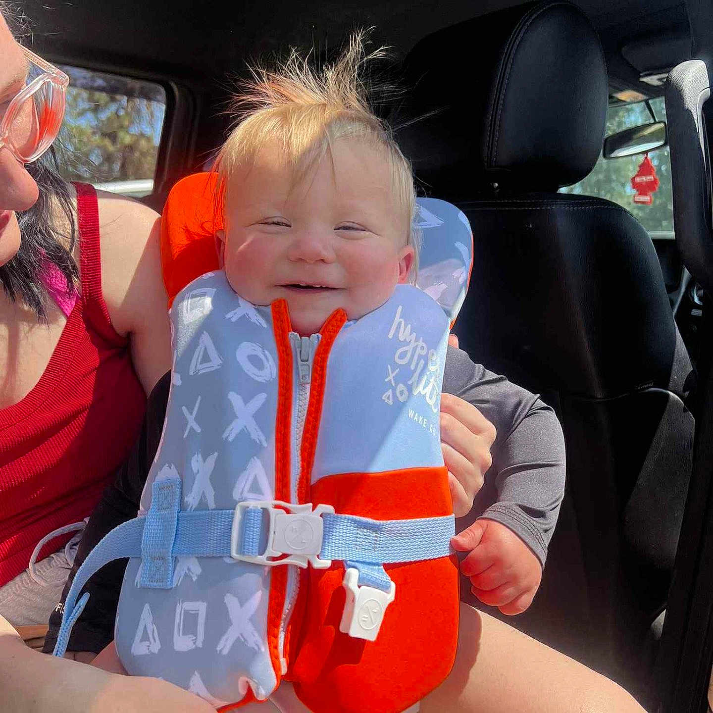 Summit joined the competition — help win amazing prizes! adult, baby, car_interior, car_seat, casual, child, clothing, glasses, hair, hand, happy, life_jacket, person, red_nail_polish, safety, seat, seatbelt, smiling, sunlight, window