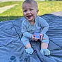 Summit is registered to the contest to win money with this photo: baby, child, smiling, toy, block, blanket, outdoor, grass, socks, sitting, happy, face, clothing, person, cute, playtime, sunny, daylight, infant, portrait