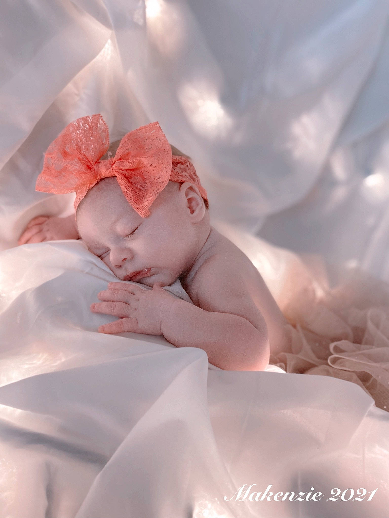 Makenzie is registered to the contest to win money with this photo: arm, baby, bridal_accessory, comfort, dress, eyelash, finger, hand, happy, headpiece, linens, nail, neck, person, petal, pink, shoulder, skin, textile, toddler