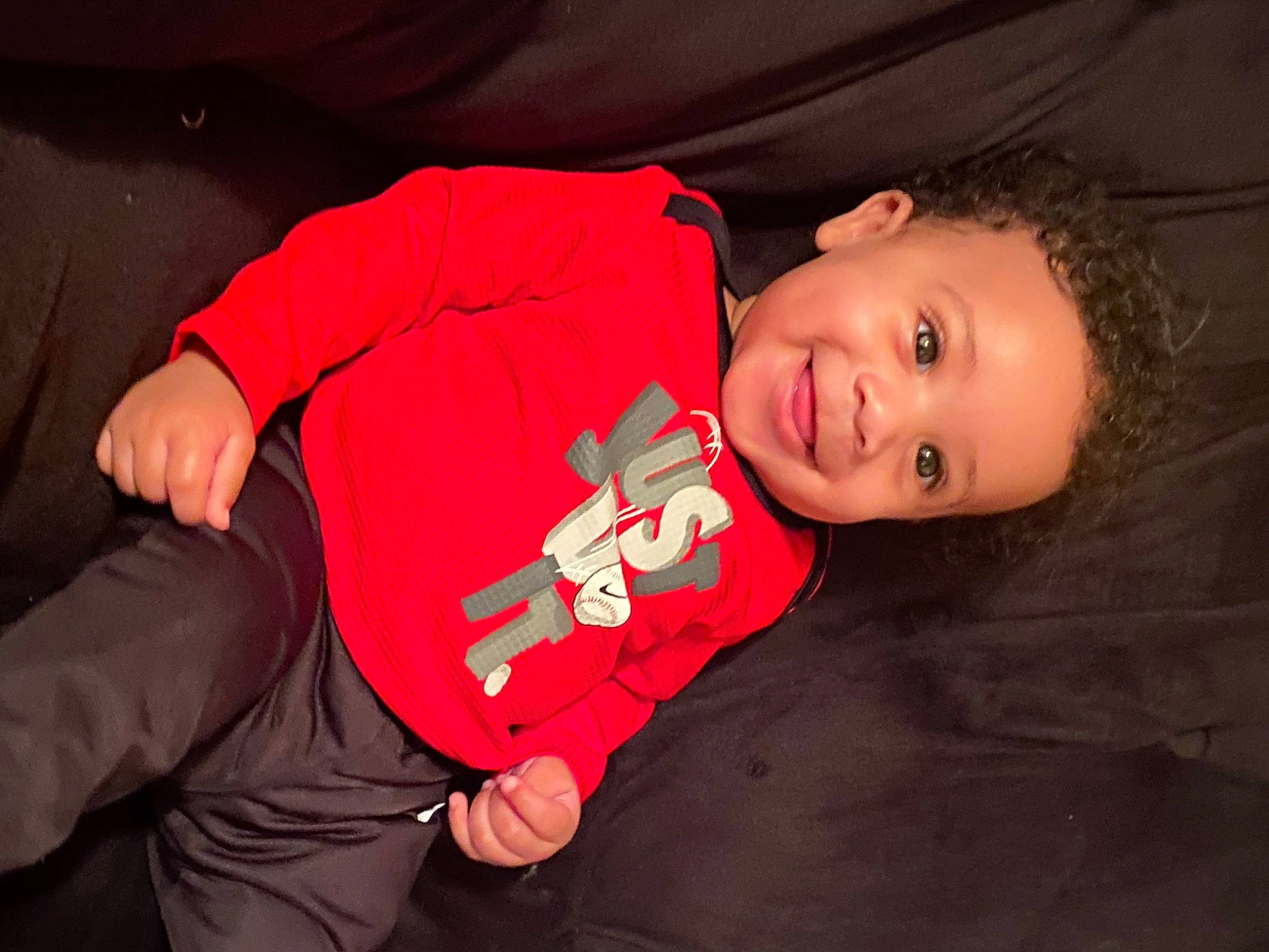 Bronx is registered to the contest to win money with this photo: baby, baby_toddler_clothing, carmine, cheek, child, comfort, elbow, finger, flash_photography, fun, happy, joy, mouth, nose, orange, person, room, sleeve, smile, t_shirt
