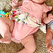Bonnie joined the competition — help win amazing prizes! baby, infant, pink_outfit, carpet, child, cute, lying_down, floral_pattern, skin, hand, foot, face, expression, indoors, clothing, person, young_child, curious, real_photo, casual