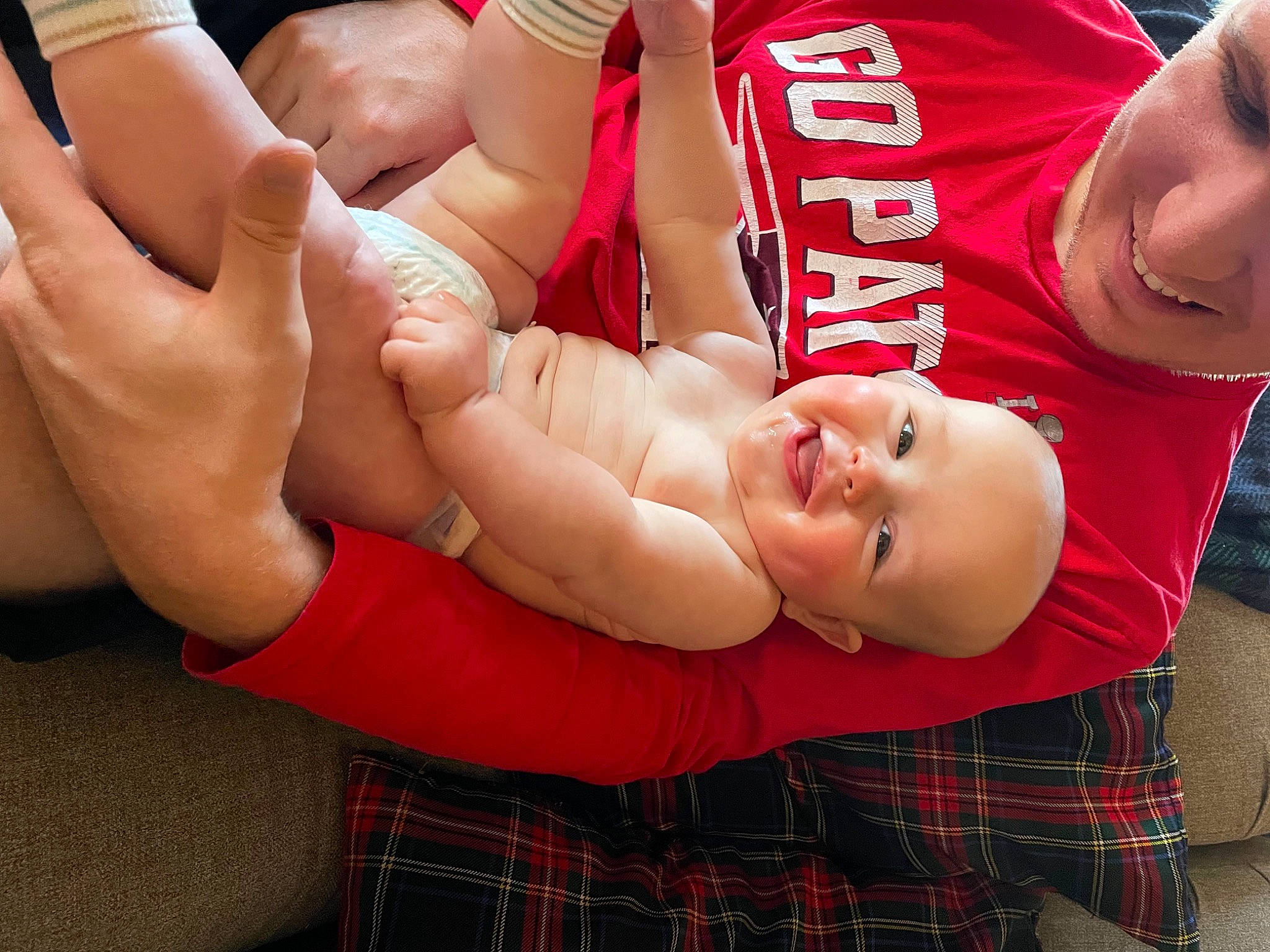 Owen is registered to the contest to win money with this photo: abdomen, chest, competition_event, elbow, event, fun, gesture, human_leg, joy, knee, muscle, pattern, person, plaid, red, shorts, smile, sports, sportswear, tartan